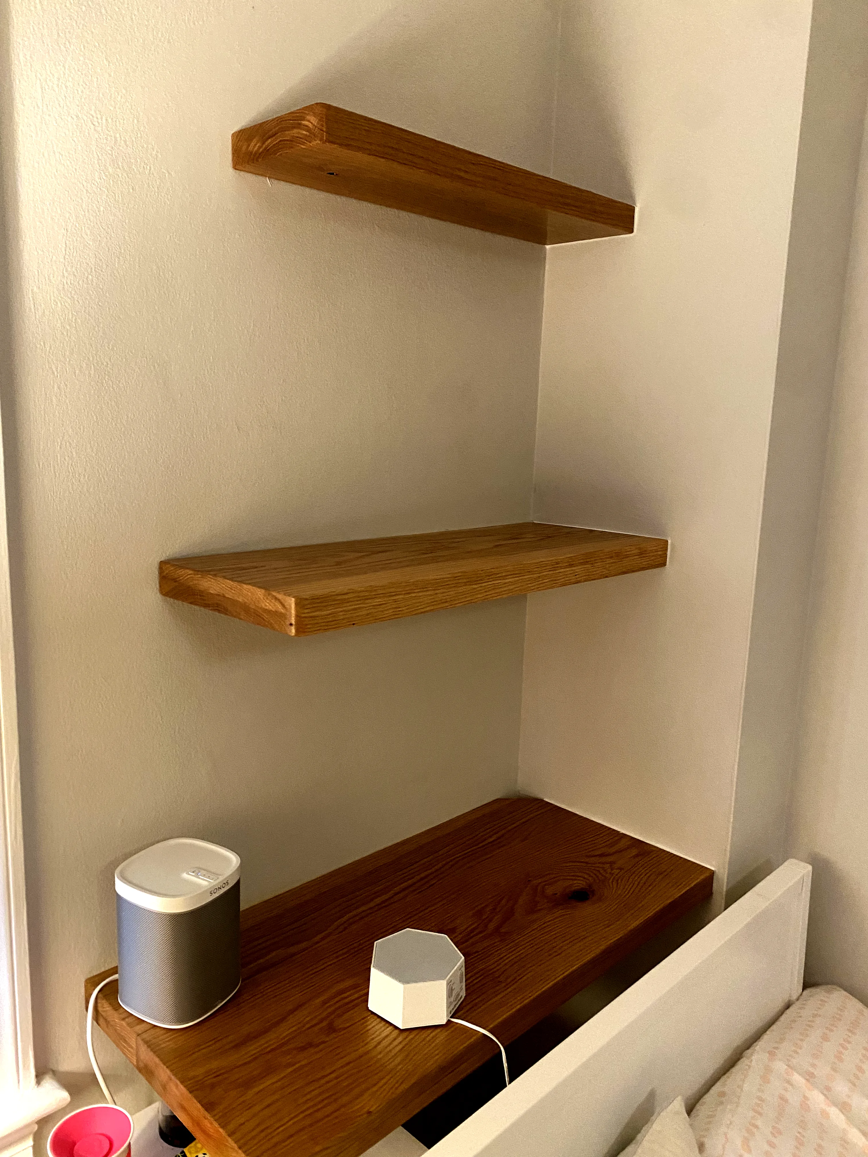 Three oak shelves in a Cathedral Heights alcove